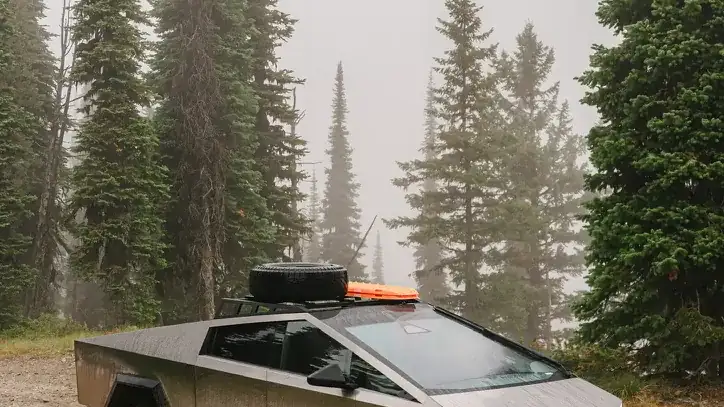 Troy's Cybertruck on a gravel pullout in a foggy alpine forest