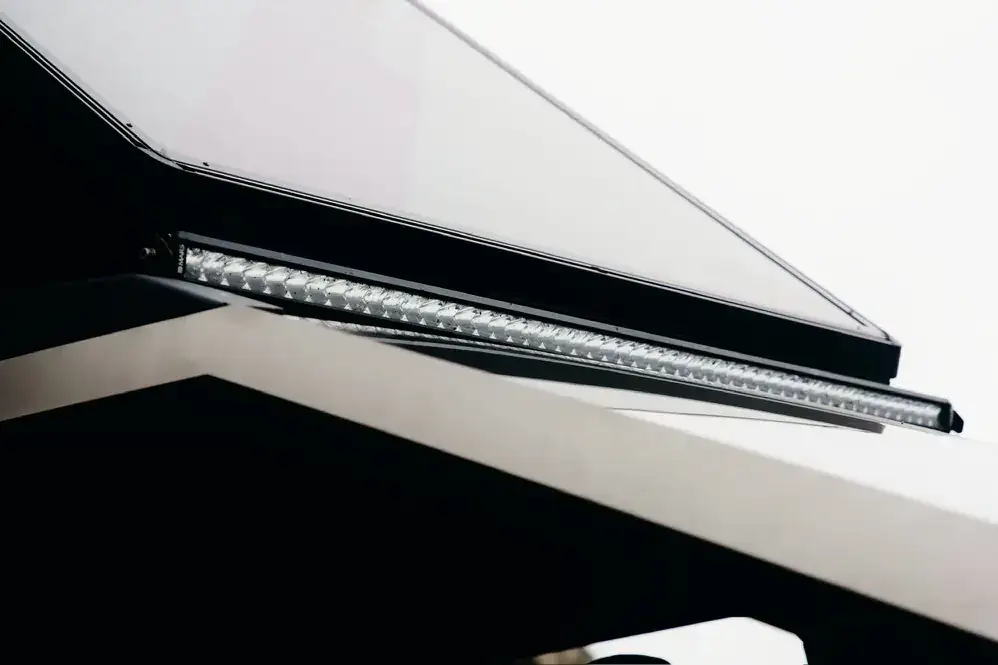 Close-up of the Cybertruck light bar and stainless hood edge