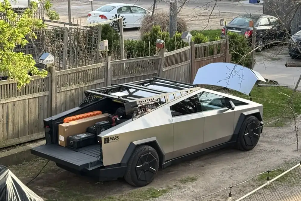 Troy's Cybertruck with the tailgate down, loaded with gear for a video shoot