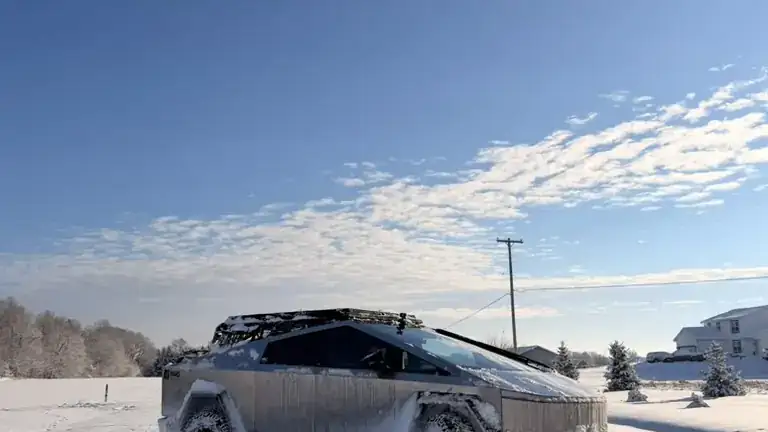 Troy's Cybertruck parked in deep snow under a blue Michigan winter sky