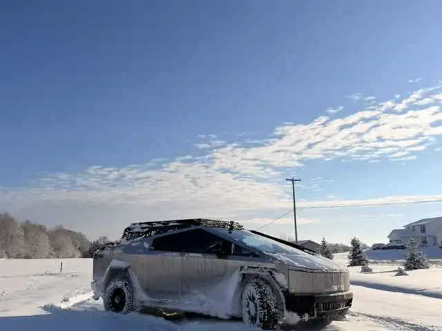 Troy's Cybertruck parked in deep snow under a blue Michigan winter sky