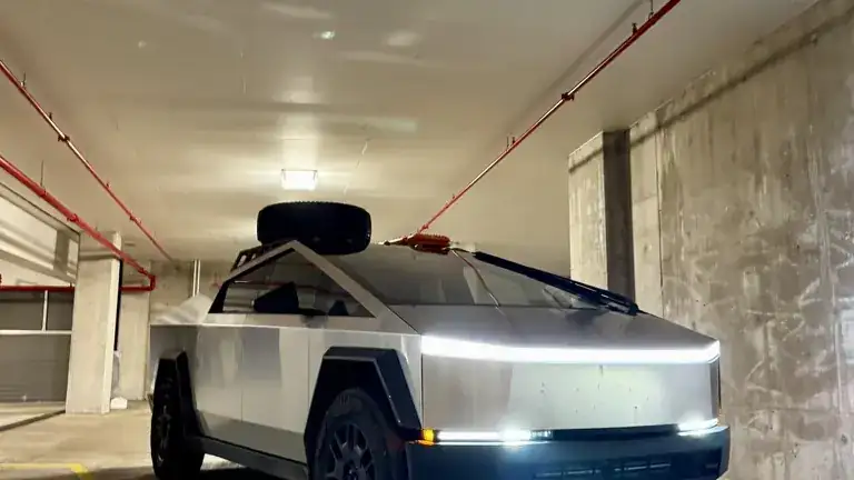 Troy's Cybertruck in a parking garage with its light bar on