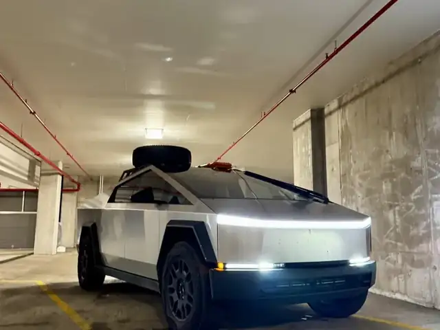 Troy's Cybertruck in a parking garage with its light bar on