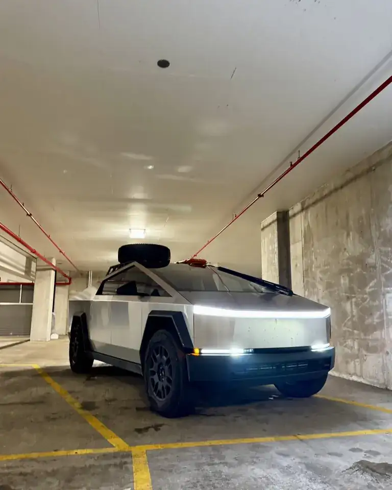 Troy's Cybertruck in a parking garage with its light bar on