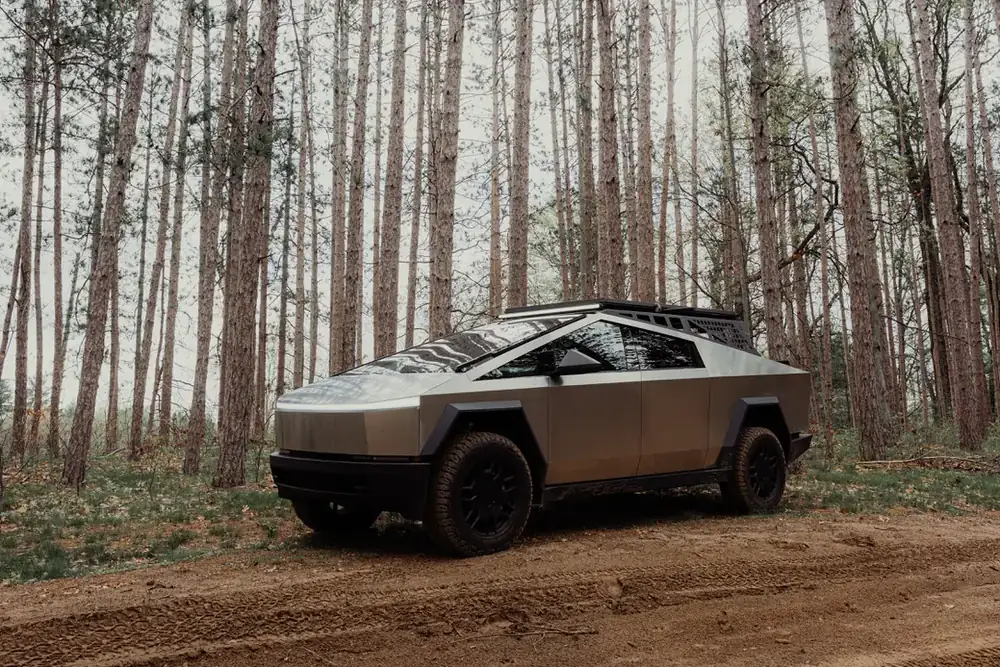Troy's Cybertruck on a sandy two-track in a Michigan pine forest