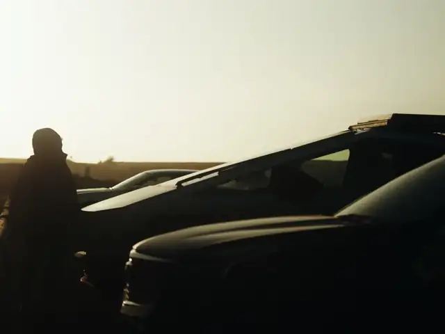 Silhouette of Troy beside the Cybertruck at sunset